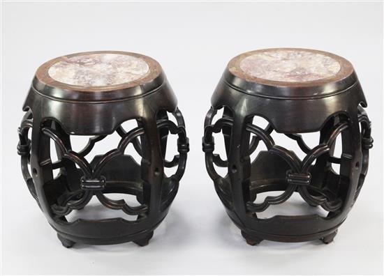 A pair of late 19th century Chinese marble inset rosewood barrel shaped stands or stools, H.53cm